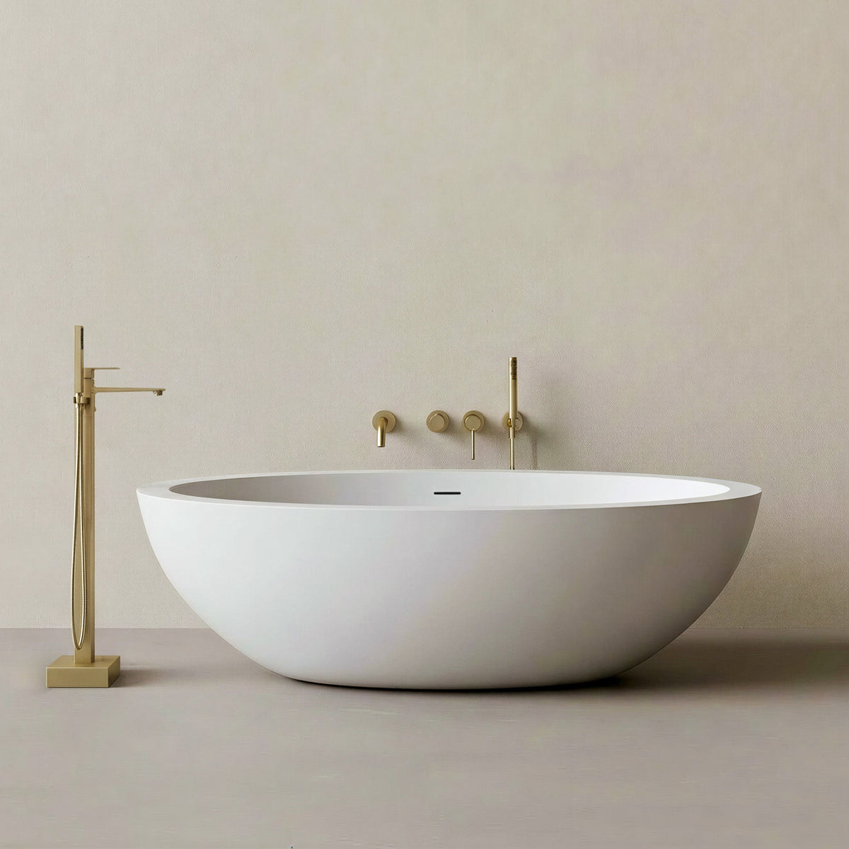 LUNARA freestanding solid surface soaking bathtub with a floor-mounted gold tub filler