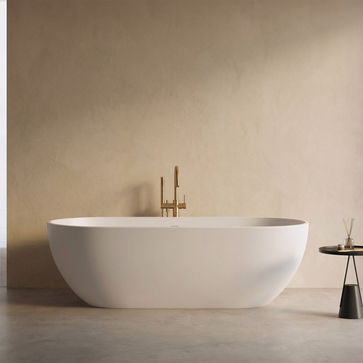 AURELLE 69-inch minimalist oval freestanding solid surface bathtub with brushed gold faucet in a beige bathroom