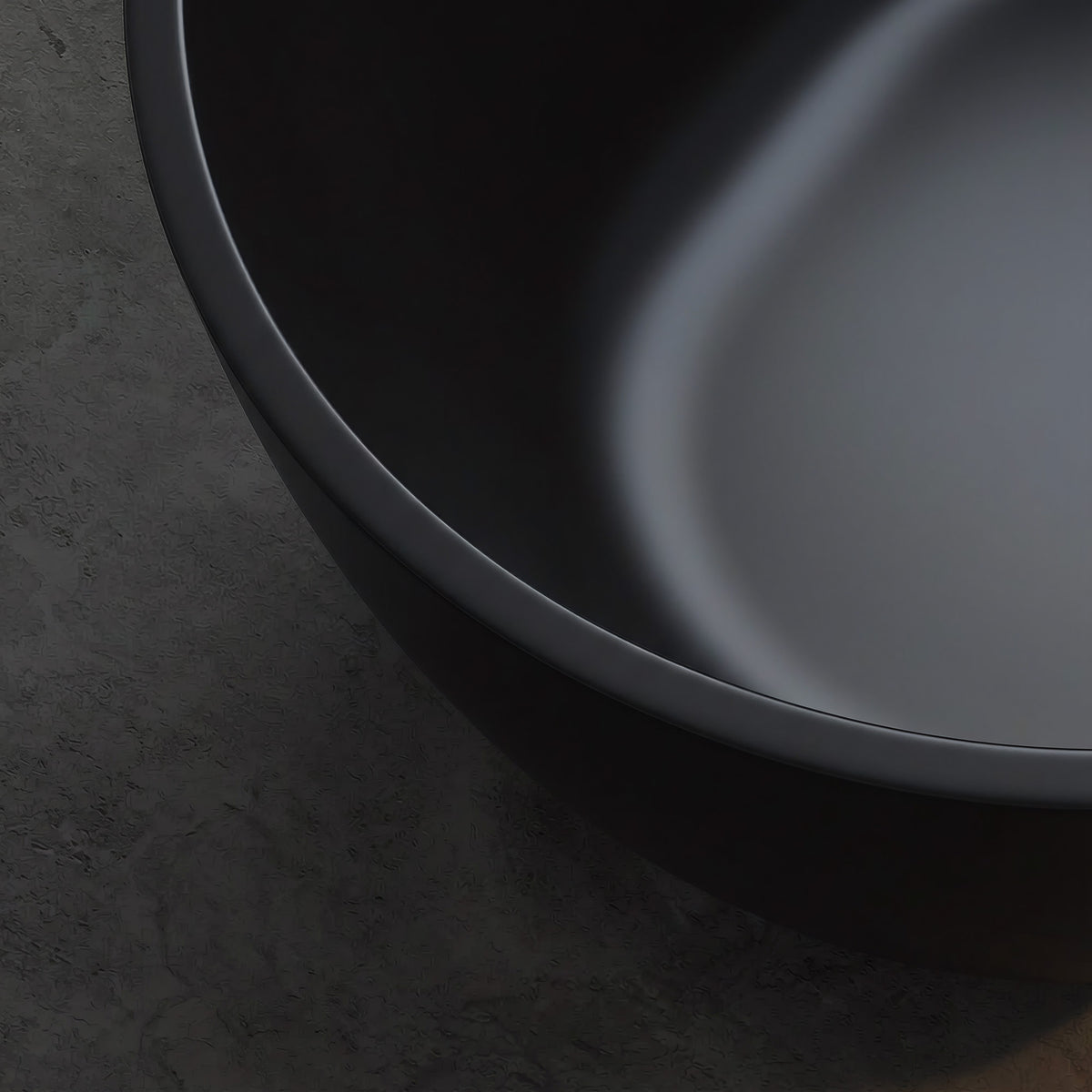 OBSIDIAN freestanding soaking bathtub with smooth black solid surface rim and curved interior