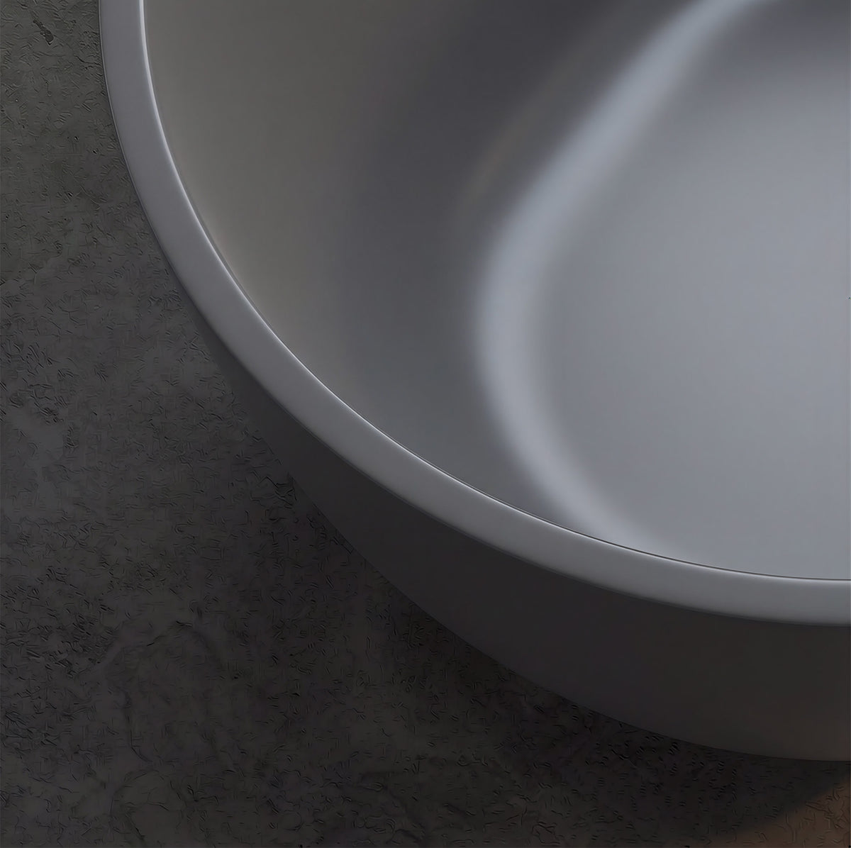 OBSIDIAN freestanding soaking bathtub close-up of smooth white solid surface rim